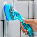 Close-up of Scotch-Brite dishwand cleaning tiled grout with blue sponge head and soap running down the tiles
