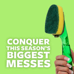 Close-up of a green dishwand head and scrub pad with a hand gripping the translucent green handle and text about conquering big messes.