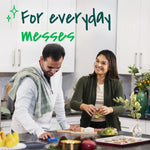 Two people in a kitchen using blue sponges at a counter with overlaid text ‘For everyday messes’