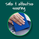 Close-up circular photo of a hand scrubbing a pan with a blue Scotch-Brite Zero Scratch pad and headline text