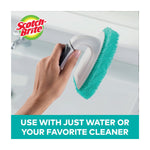 Hand holding a Scotch-Brite scrubber head being used on a bathtub surface, with logo and usage text at bottom