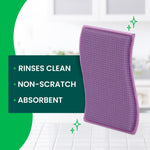 Close-up of a purple Scotch-Brite scrubbing pad with a text panel listing benefits: 'Rinses Clean, Non-Scratch, Absorbent'.