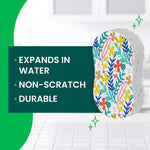 Close-up graphic of a floral-patterned pop-up sponge with text bullets noting expands in water, non-scratch, durable.