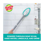 Scotch-Brite scrubber attached to an extendable handle cleaning white tiled shower wall with logo and feature text
