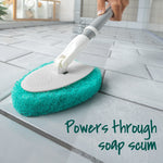 Close-up of the scrubber pad attached to the handle used on floor tile, showing textured green scouring pad and swivel head.