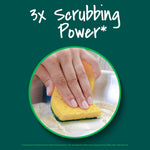 Close-up of a hand using a yellow-and-green Scotch-Brite sponge on a metal surface with '3x Scrubbing Power' heading.