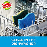 Two Scotch-Brite scrub sponges placed inside a dishwasher rack beside glassware, brand logo visible