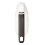 Top-down view of a Scotch-Brite scrub brush showing dark gray handle and bristles visible around the head