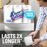 Scott 1000 toilet paper pack displayed on a bathroom surface with person handling a roll