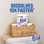 Two Scott 1000 toilet paper rolls in a woven basket on a bathroom surface with 'Dissolves 10X Faster' text