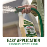 Hand-held Scotts Turf Builder bottle connected to a hose spraying water, demonstrating easy application