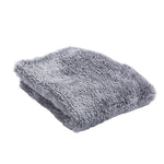 Folded gray Scrub Daddy microfiber cloth isolated on white, highlighting plush fibers