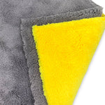 Close-up of folded gray and yellow Scrub Daddy microfiber cloths showing plush texture