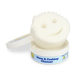 Open Scrub Daddy cleanser tub with a smiling white Scrub Mommy style sponge seated on top