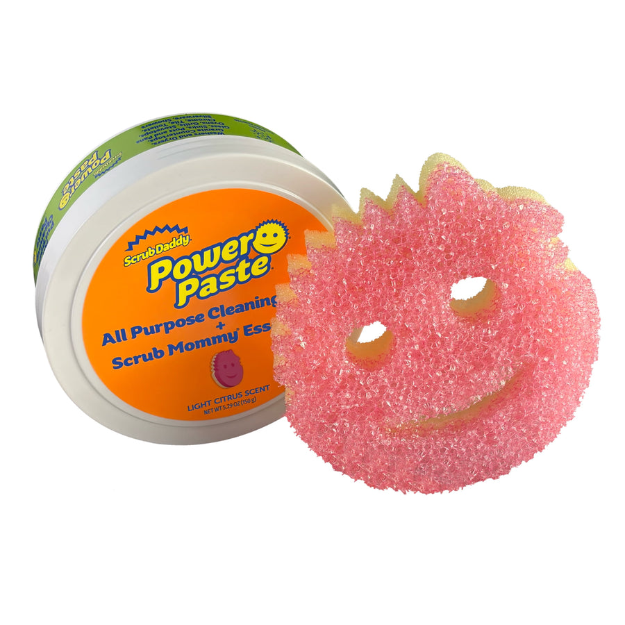 Scrub Daddy PowerPaste tub tilted with pink Scrub Mommy Essentials smiling sponge beside it on white background