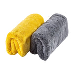 Two rolled Scrub Daddy microfiber towels in yellow and gray displayed side by side