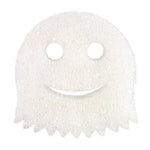 Close-up of a white Scrub Daddy sponge cut in a ghost shape with round eye holes and a smiling mouth.