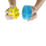 Two hands holding a yellow Scrub Hub handle and a blue round scrub sponge, showing the detachable scrub pad
