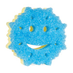 Top-down view of a blue snowflake-shaped Scrub Mommy scrubber showing the textured abrasive surface and smile-face cutouts.