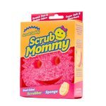 Angled view of Scrub Mommy yellow-orange retail box showing pink smile-face scrubber inside