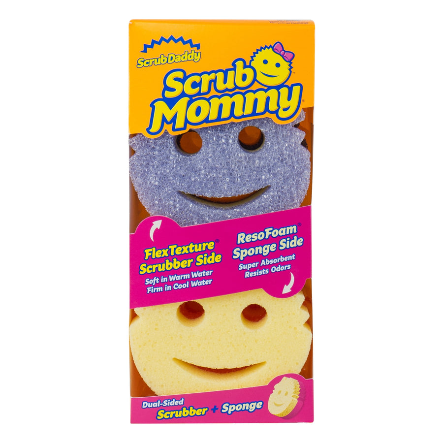 Front-facing Scrub Mommy retail package showing two smile-face sponges and product callouts on bright orange box.