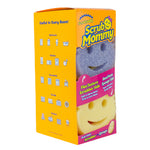 Angled view of Scrub Mommy packaging with visible icons for rooms of the house and two smile-face sponges inside.