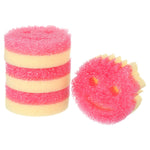 Stack of pink-and-yellow round smiling Scrub Mommy sponges with one sponge face visible