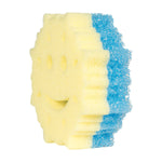 Angled side view of a Scrub Mommy snowflake sponge showing the layered yellow foam and blue scrubber material and smile cutout.