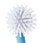 Close-up top view of round white bristle head of a dish scrubber showing dense radial brushes