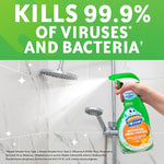Hand spraying Scrubbing Bubbles bottle at a tiled showerhead with bold text claiming it kills 99.9% of viruses and bacteria