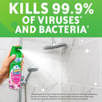 Hand spraying Scrubbing Bubbles aerosol toward shower head with headline claiming it kills 99.9% of viruses and bacteria.