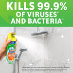 Hand spraying Scrubbing Bubbles Bathroom Grime Fighter aerosol at tiled shower, kills 99.9% claim visible