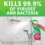 Hand spraying Scrubbing Bubbles cleaner in a tiled shower with bold text claiming it kills 99.9% of viruses and bacteria