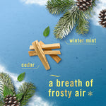 Illustration of cedar wood sticks, frosted pine branches and text describing scent notes like cedar and winter mint