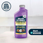 Purple Shark HYDRO hardwood concentrate bottle on a kitchen counter with Shark Genuine badge.