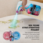 Hand-held Shark StainForce spray head dispensing blue cleaning solution onto a stained fabric surface with product icons and callout text.