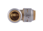 Close-up end-on view into one side of a SharkBite-style brass elbow fitting, showing internal sleeve and seals.