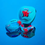 Three blue Shock Doctor Kool-Aid branded mouthguard cases and a mouthguard reflected on a glossy surface