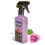 Angled shot of a pink Shubug 3in1 plant spray bottle beside a pink rose on a white background.