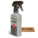 Angled Shubug home pest control spray bottle standing beside a small welcome doormat on a white background.