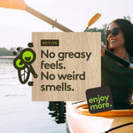 Kayaking lifestyle image with wood-textured overlay reading “No greasy feels. No weird smells.” and Shübug branding.