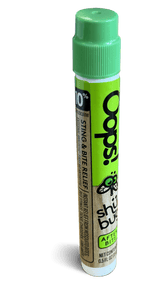 Angled Shübug Oops! pen standing upright showing green cap and partial label text indicating sting & bite relief.