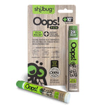 Retail packaged Shübug Oops! pen standing next to a separate Oops! pen lying in front of the package.