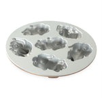 Silver-toned round baking pan shown flat with six bunny-shaped molds visible from an angled view