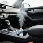 Small Simoniz fogger can placed in a vehicle cupholder releasing a visible mist into the cabin