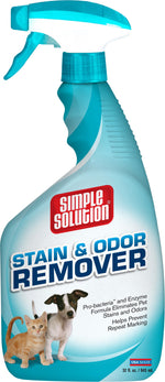Close-up front view of a Simple Solution spray bottle labeled “Stain & Odor Remover” featuring a kitten and puppy on the label.