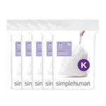 Five stacked white simplehuman dispenser packs showing a tied white trash bag and purple 'K' badge.