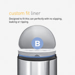 Stainless step trash can with its lid open showing a white custom-fit liner and a blue B badge on the rim.