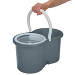 Grey mop bucket with integrated spinner basket and a hand holding the white carry handle