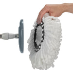 Hand holding a removable white microfiber mop pad beside the mop's round grey plastic attachment plate
